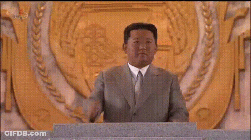 Man In Suit Giving Speech At Podium GIF
