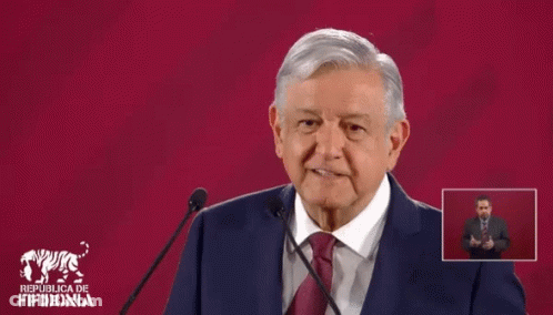 Man In Suit Giving Speech At Republica De Fifidonia Sign GIF