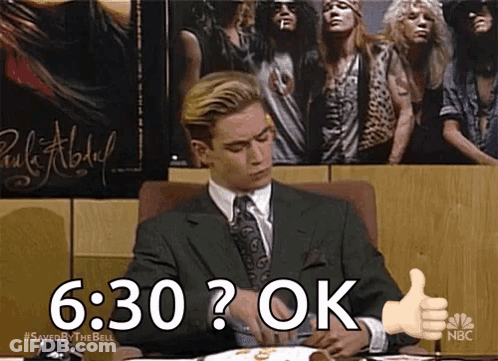 Man In Suit Giving Thumbs Up In Front Of Guns N' Roses Poster GIF