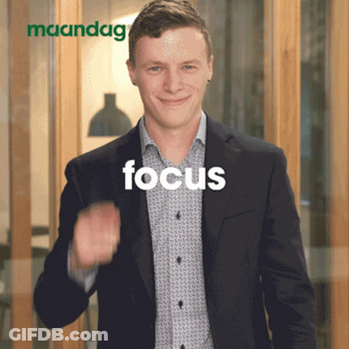 Man In Suit Giving Thumbs Up In Front Of Maandag Sign GIF