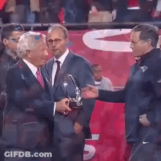 Man In Suit Giving Trophy To Another Man GIF