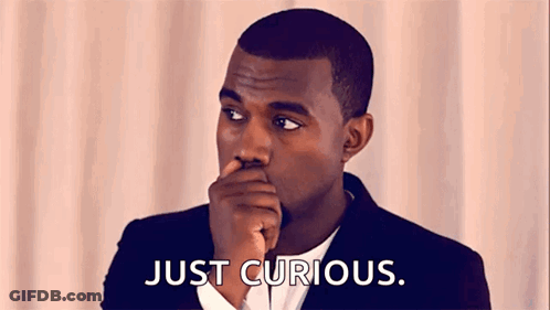 Man In Suit Hand To Mouth Just Curious GIF