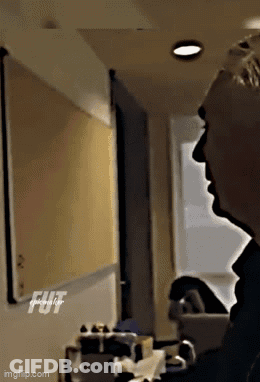 Man In Suit Hands In Pockets Dark Room GIF