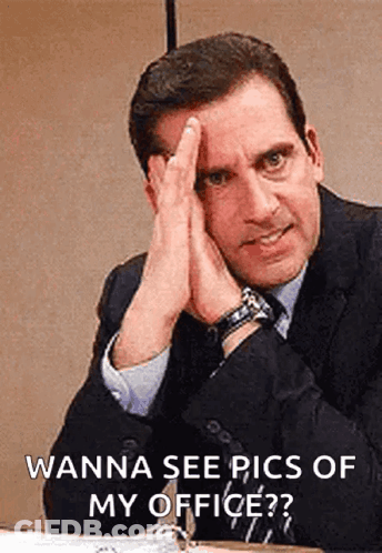 Man In Suit Hands On Face At Desk GIF