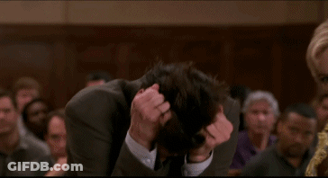 Man In Suit Hands On Head In Crowd GIF