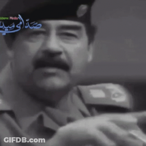 Man In Suit Hat Holding Sword Arabic News GIF