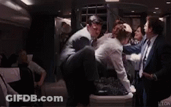 Man In Suit Held By Another In Limo GIF