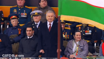 Man In Suit Holding AA Flag GIF