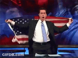 Man In Suit Holding American Flag GIF
