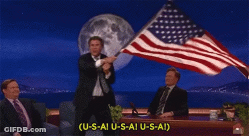 Man In Suit Holding American Flag Saying USAI USAI GIF