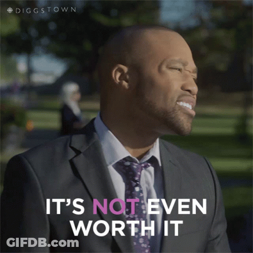 Man In Suit Holding Awaiting Trains Sign GIF