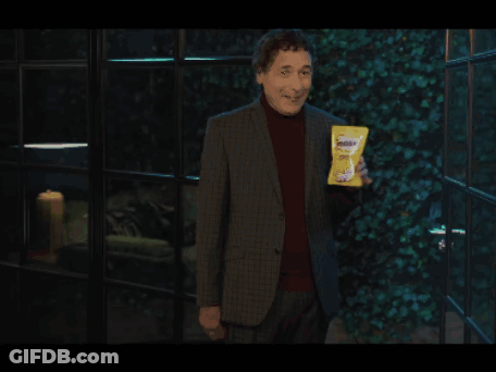 Man In Suit Holding Bag Of Doritos GIF