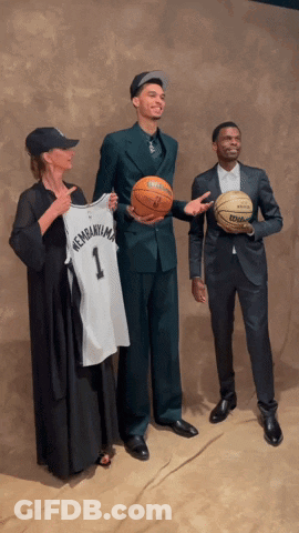 Man In Suit Holding Basketball And Jersey GIF