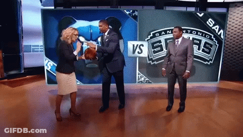 Man In Suit Holding Basketball In Front Of VS Sign GIF