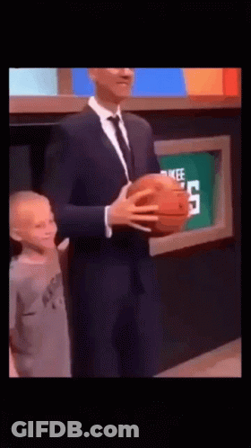 Man In Suit Holding Basketball Next To Child GIF
