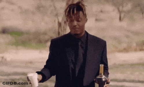 Man In Suit Holding Bottle And Coffee GIF