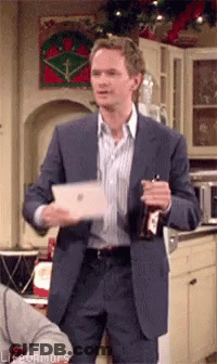 Man In Suit Holding Bottle And Tablet GIF
