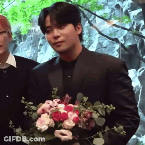 Man In Suit Holding Bouquet GIF