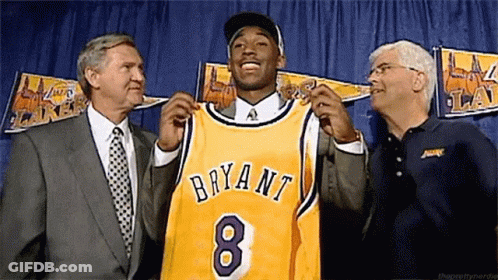 Man In Suit Holding Bryant 8 Jersey GIF