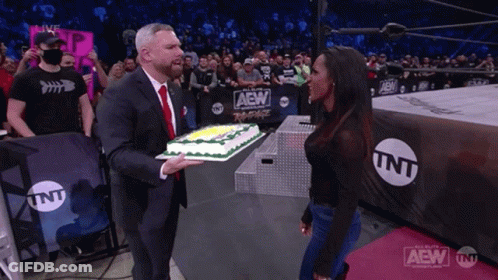 Man In Suit Holding Cake In Wrestling Ring TNT GIF