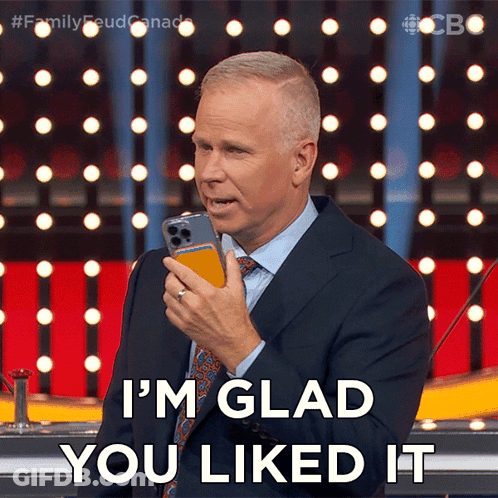 Man In Suit Holding Cell Phone Says I'm Glad You Liked It GIF