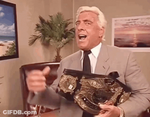 Man In Suit Holding Championship Belt GIF