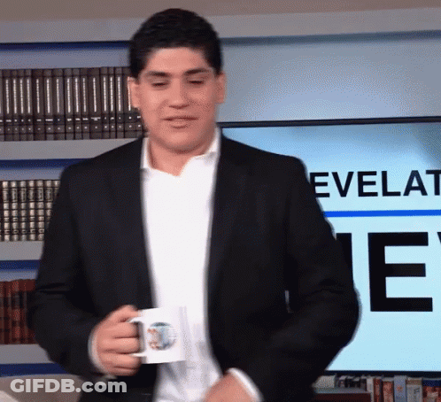 Man In Suit Holding Coffee Mug In Front Of Screen Saying Revelati GIF