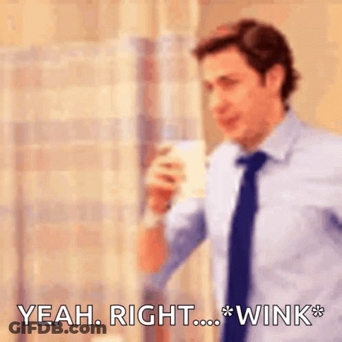 Man In Suit Holding Coffee Saying Yeah Right Wink GIF