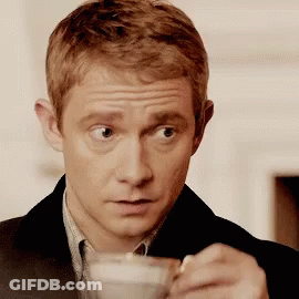 Man In Suit Holding Coffee With Spoon GIF