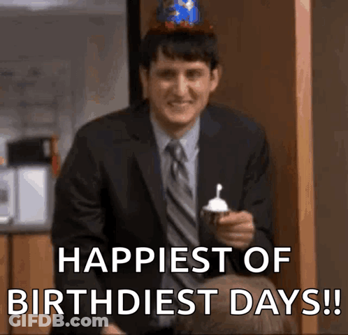 Man In Suit Holding Cupcake Saying Happiest Of Birthdest Days GIF