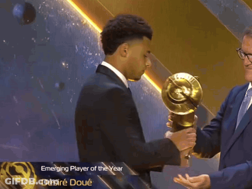 Man In Suit Holding Emerging Player Of The Year Trophy GIF