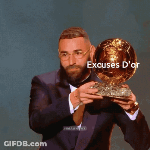 Man In Suit Holding Excuses D'Or Trophy GIF
