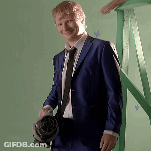 Man In Suit Holding Fan GIF