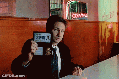 Man In Suit Holding FBI Badge GIF