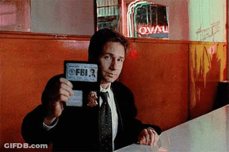 Man In Suit Holding FBI Badge GIF