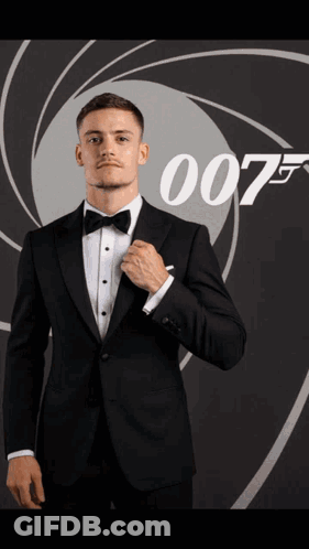 Man In Suit Holding Fireball In Front Of 007 Poster GIF