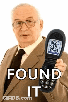 Man In Suit Holding Flip Phone Saying Found It GIF