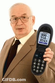 Man In Suit Holding Flip Phone With 800-918-8543 On Screen GIF