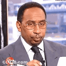 Man In Suit Holding Football Helmet GIF