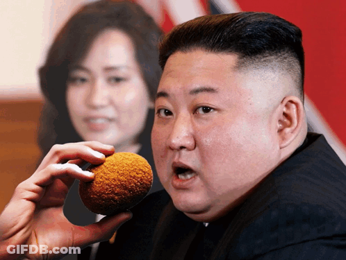 Man In Suit Holding Fried Food GIF