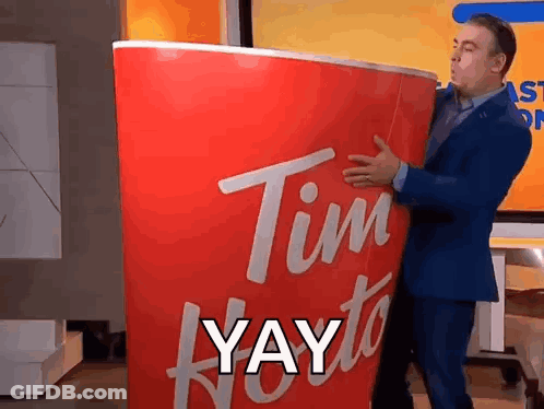 Man In Suit Holding Giant Tim Hortons Cup GIF