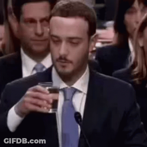 Man In Suit Holding Glass Of Wine GIF