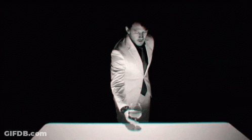 Man In Suit Holding Glass Of Wine GIF