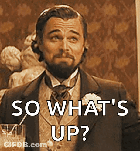 Man In Suit Holding Glass Says So What's Up GIF