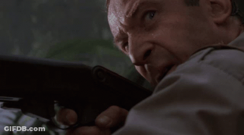 Man In Suit Holding Gun GIF