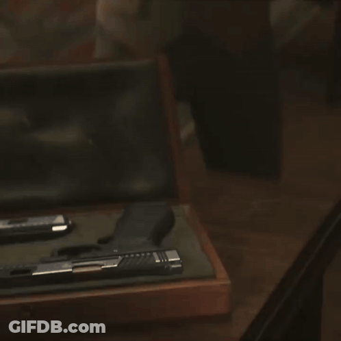 Man In Suit Holding Gun GIF