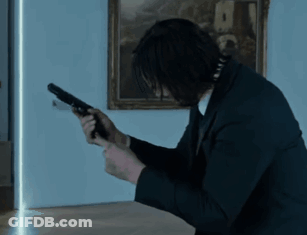 Man In Suit Holding Gun GIF