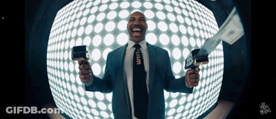 Man In Suit Holding Gun And Stack Of Money GIF