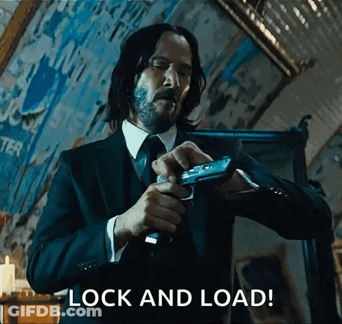 Man In Suit Holding Gun GIF