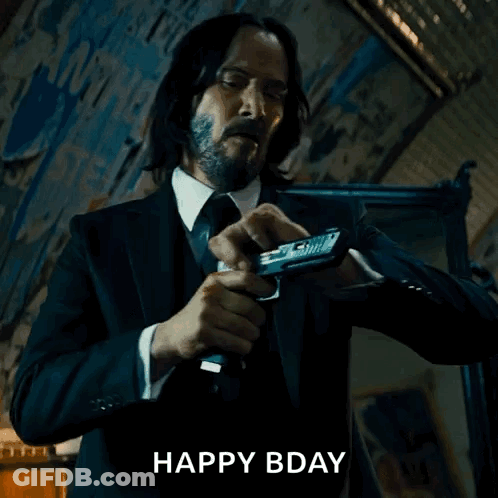 Man In Suit Holding Gun Saying Happy Bday GIF